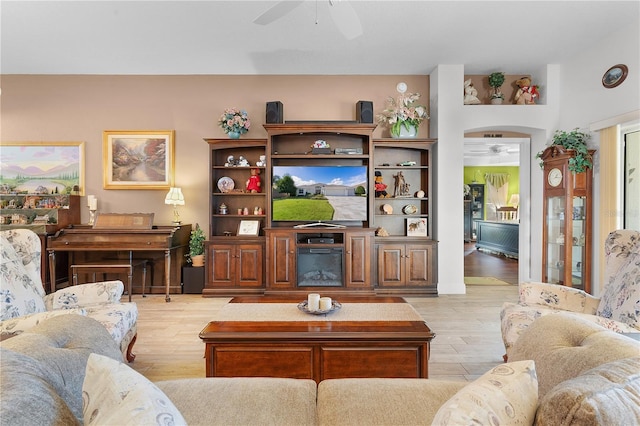 living room with light wood-type flooring and ceiling fan