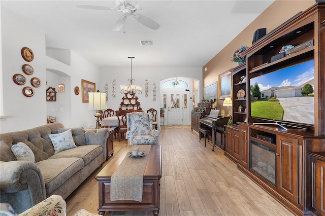 living room featuring light hardwood / wood-style floors and ceiling fan with notable chandelier