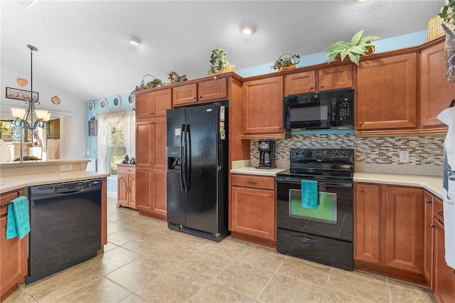 kitchen with backsplash, an inviting chandelier, black appliances, hanging light fixtures, and vaulted ceiling