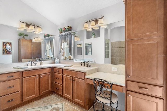 bathroom featuring tile patterned flooring, vanity, and lofted ceiling