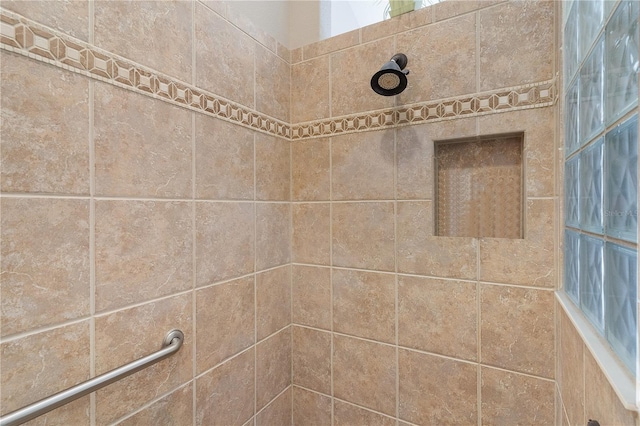 bathroom with tiled shower