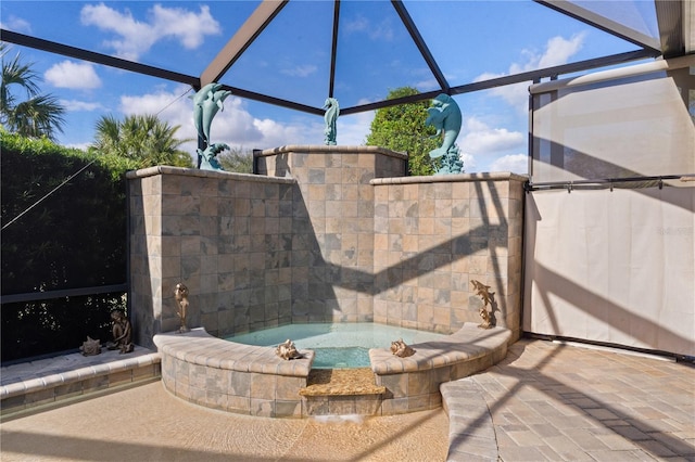 view of patio / terrace with an in ground hot tub