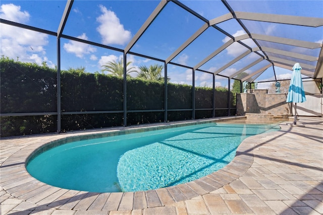 view of pool featuring a patio and glass enclosure