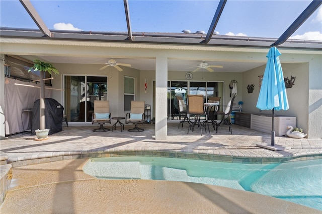 view of swimming pool with grilling area, ceiling fan, and a patio area