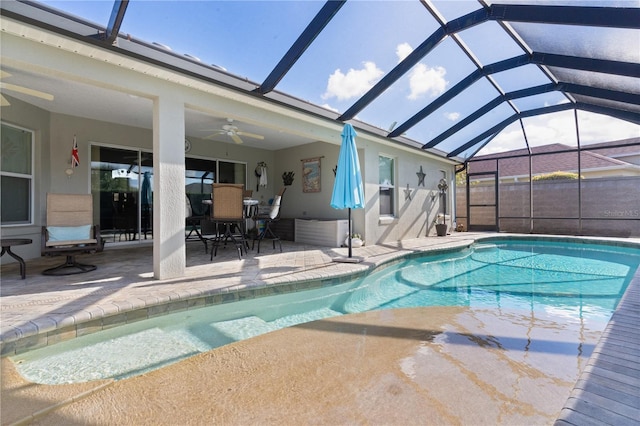 view of swimming pool featuring a lanai, ceiling fan, and a patio area