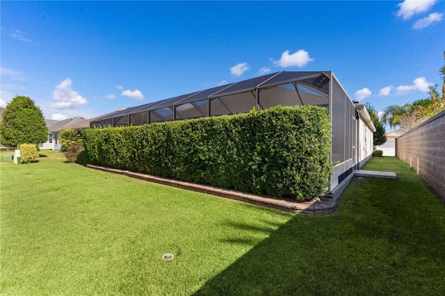 view of yard with glass enclosure