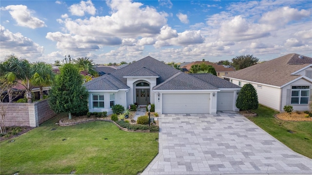 single story home featuring a garage and a front lawn