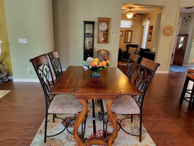 dining room featuring ceiling fan and dark hardwood / wood-style flooring