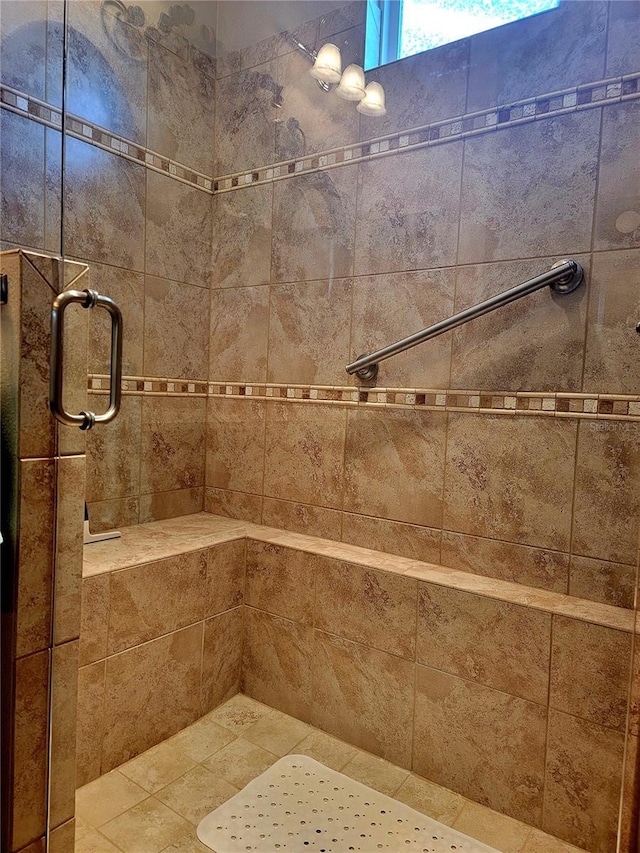 bathroom featuring a shower with door