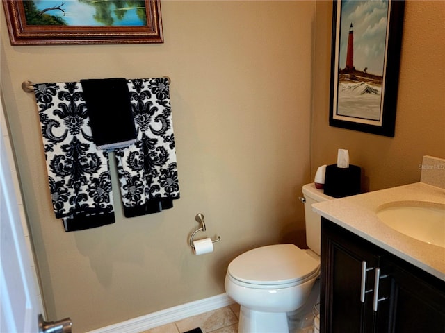 bathroom with tile patterned floors, vanity, and toilet