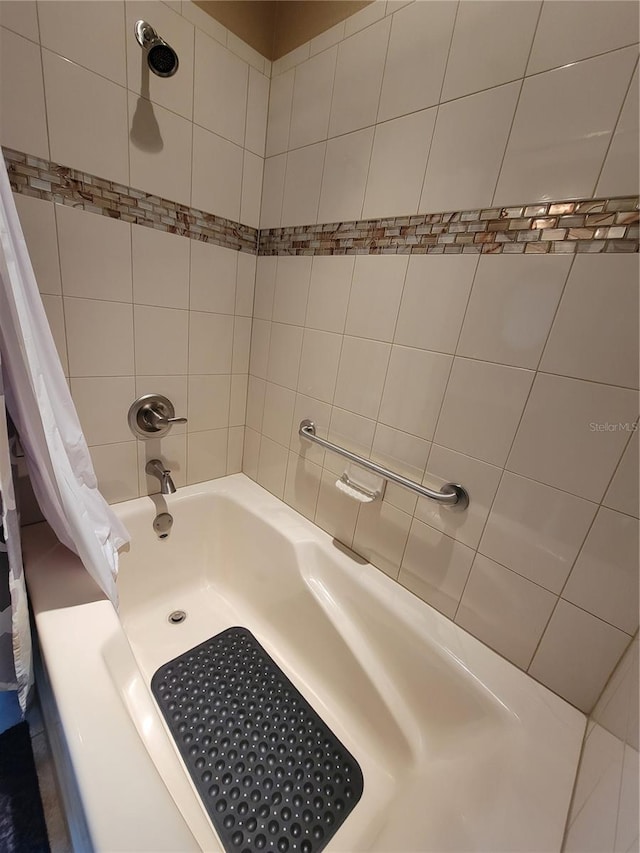 bathroom with shower / bath combo with shower curtain