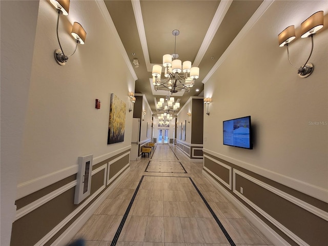 corridor with a chandelier and ornamental molding