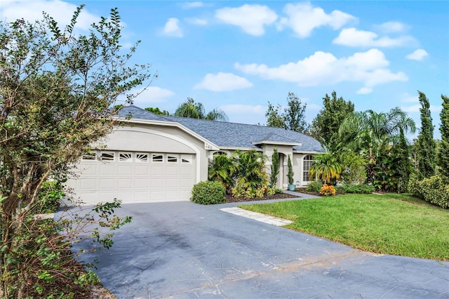 single story home featuring a garage and a front lawn