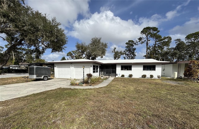 ranch-style home with a garage and a front lawn