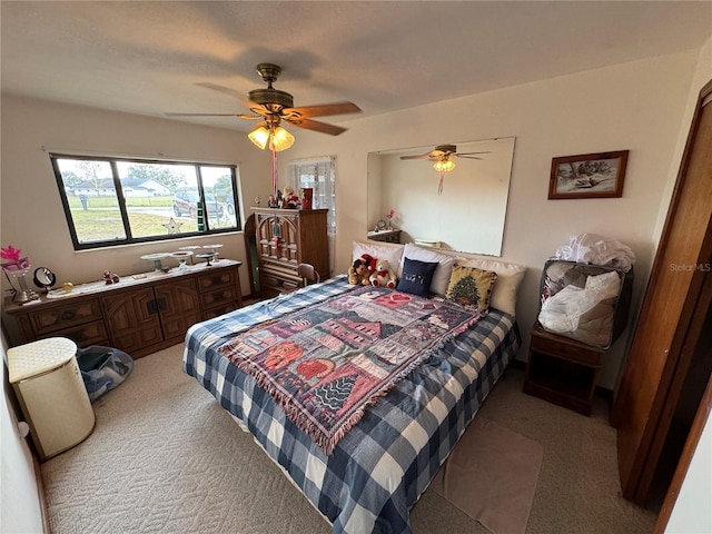 bedroom with ceiling fan and light colored carpet