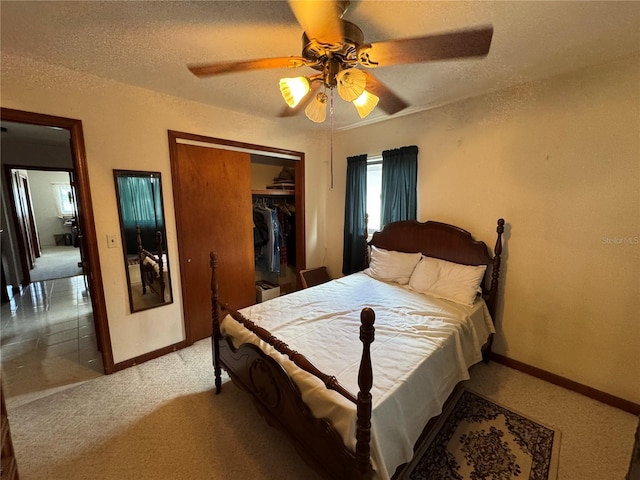 carpeted bedroom with ceiling fan, a textured ceiling, and a closet