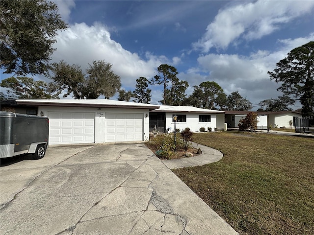 single story home featuring a garage and a front lawn