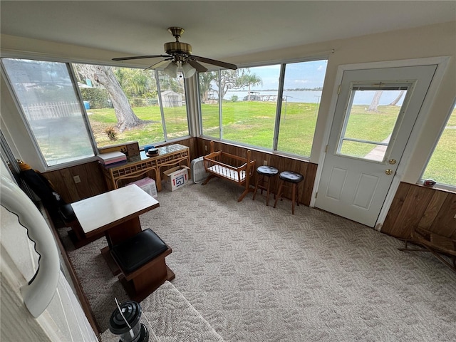 sunroom featuring ceiling fan and a healthy amount of sunlight