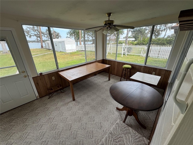 sunroom featuring ceiling fan and plenty of natural light