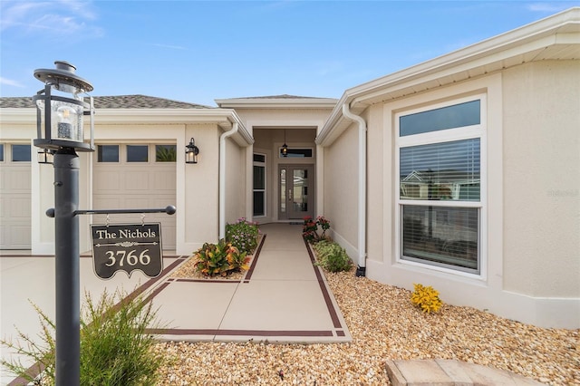 view of exterior entry with a garage