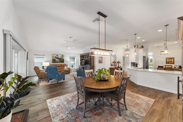 dining room featuring dark hardwood / wood-style flooring, ceiling fan, and sink