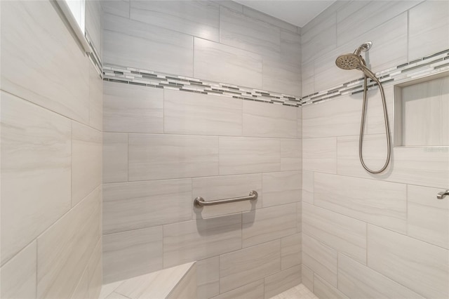 bathroom with tiled shower