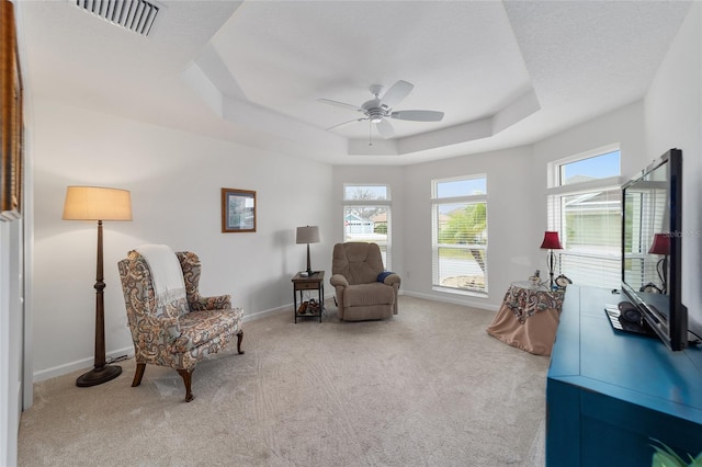 sitting room featuring plenty of natural light and light carpet