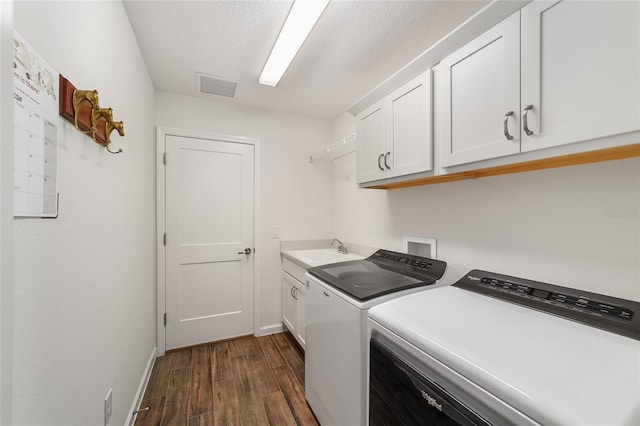 clothes washing area featuring separate washer and dryer, cabinets, sink, and dark wood-type flooring