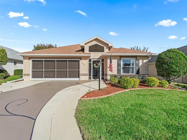 view of front of property with a front lawn and a garage