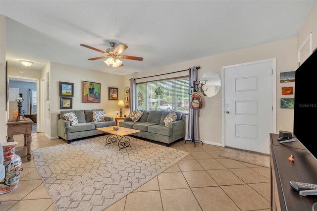 living room featuring light tile patterned floors and ceiling fan