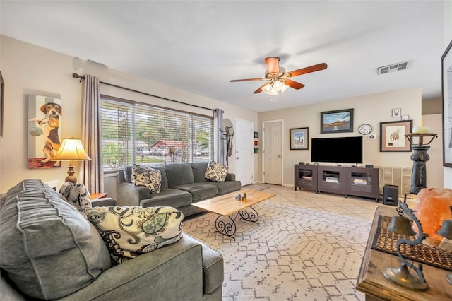 tiled living room with ceiling fan