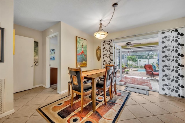 dining area featuring light tile patterned floors and ceiling fan