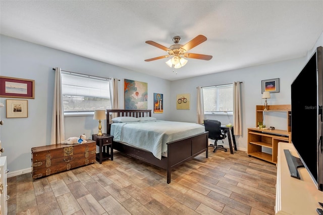 bedroom with light hardwood / wood-style floors and ceiling fan