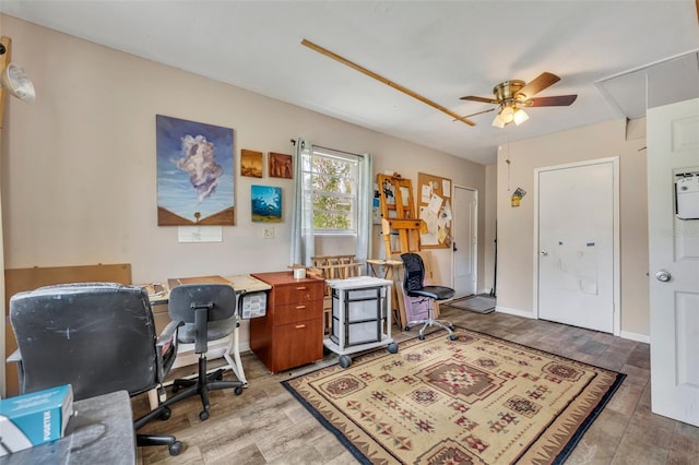 office featuring light hardwood / wood-style floors and ceiling fan