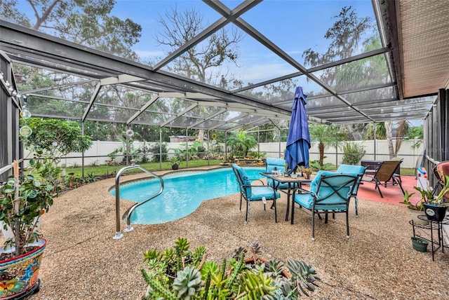 view of pool featuring glass enclosure and a patio