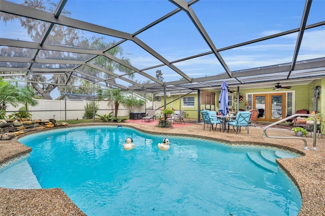 view of pool with glass enclosure, a patio area, and french doors