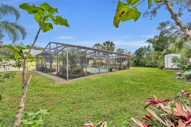 view of yard featuring glass enclosure and a storage unit