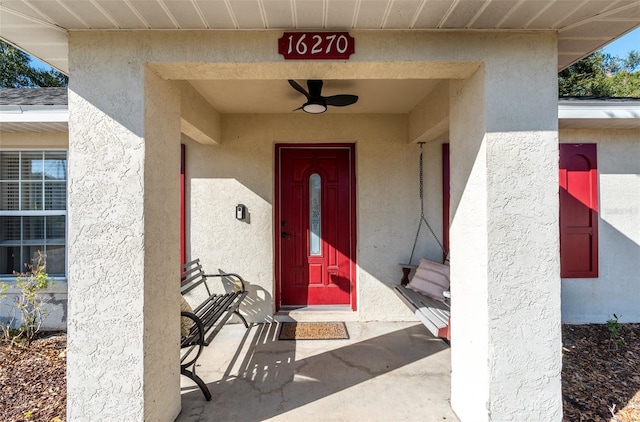 entrance to property with ceiling fan