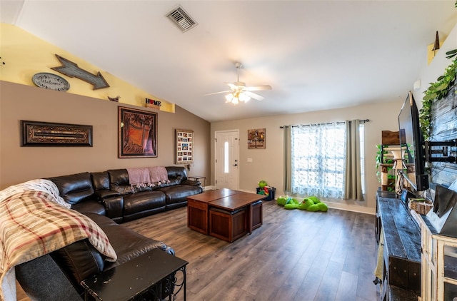 living room with ceiling fan, dark wood-type flooring, and vaulted ceiling