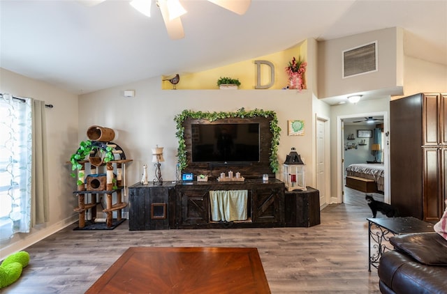 living room featuring plenty of natural light, wood-type flooring, and lofted ceiling