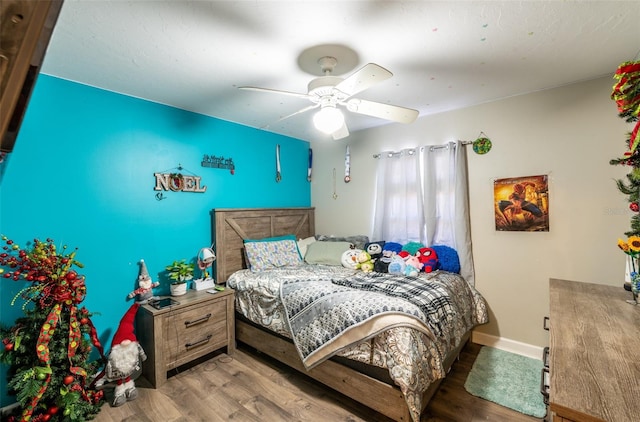 bedroom featuring wood-type flooring and ceiling fan