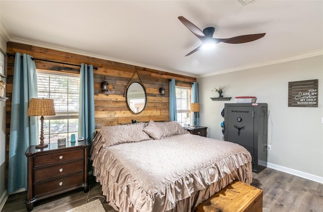 bedroom with ceiling fan, wood walls, ornamental molding, and dark wood-type flooring