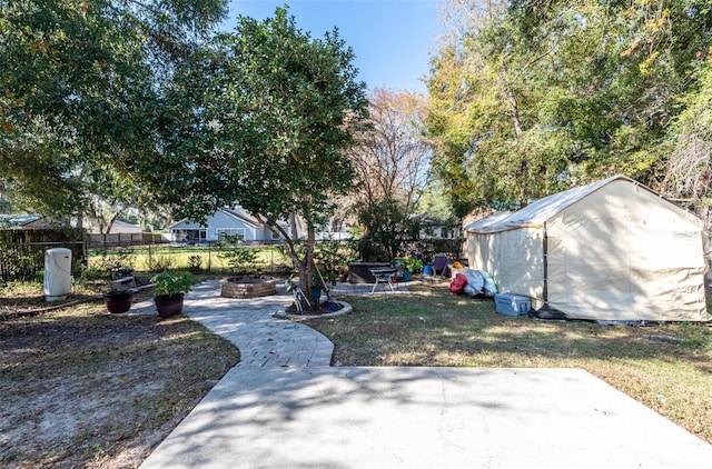 view of yard with a fire pit and a patio area