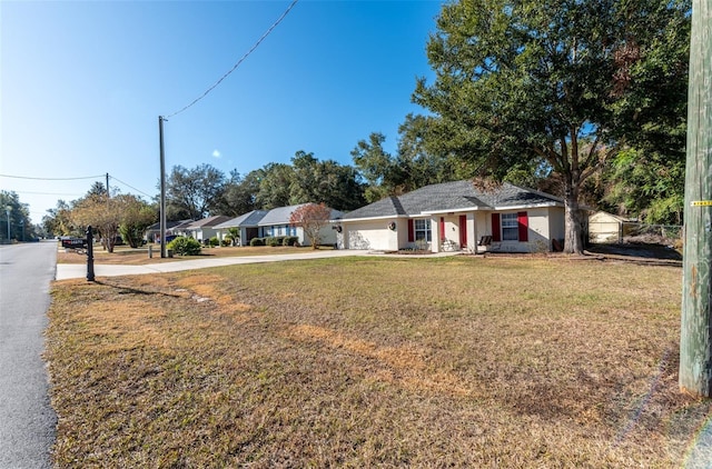 view of front of property featuring a front yard and a garage