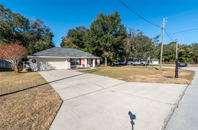 single story home with a garage and a front lawn