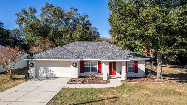 ranch-style house featuring a front lawn and a garage