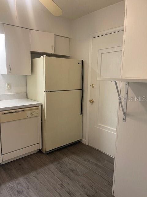 kitchen featuring white cabinetry, dark hardwood / wood-style floors, and white appliances