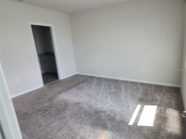 unfurnished bedroom featuring dark carpet