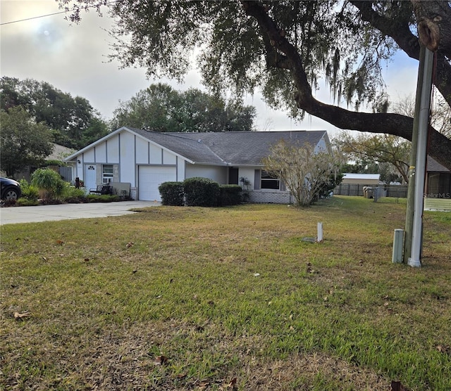 view of front of home featuring a front yard and a garage