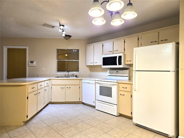 kitchen featuring kitchen peninsula, white appliances, a textured ceiling, sink, and pendant lighting